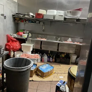 a commercial kitchen with a trash can