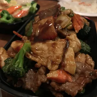a plate of stir fried meat and vegetables