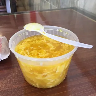 a bowl of noodles and a spoon on a table