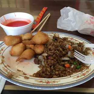 a plate of fried food with chopsticks