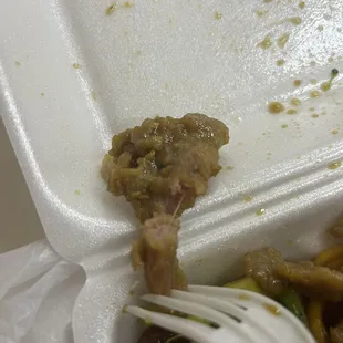 a fork in a take out container