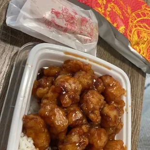 a plastic container with rice and broccoli