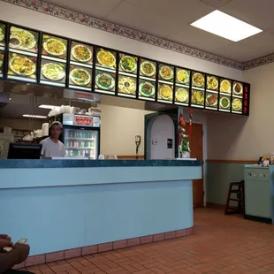 a man sitting at a counter in a restaurant