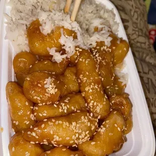 a plastic container filled with rice and meat