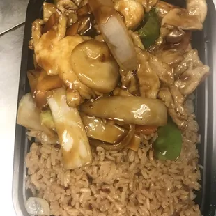 chicken, vegetables, and rice in a black container