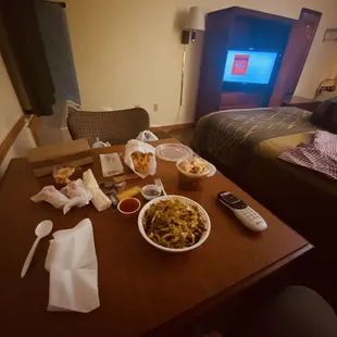 a table with food and a television in the background