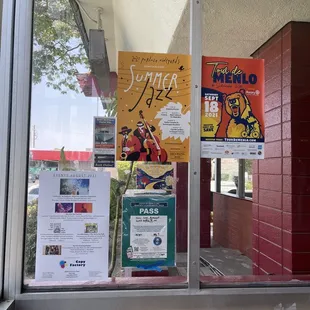 posters in a window of a restaurant