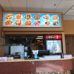 A Chinese takeout place without colorful pictures of food over the counter would be just plain wrong