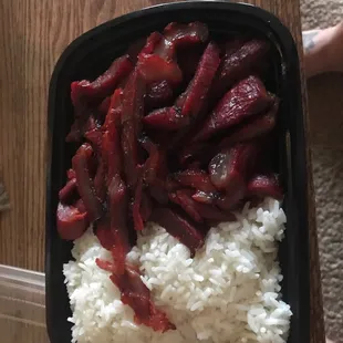 a plastic container filled with rice and meat