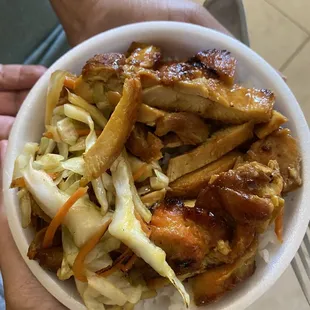 a person holding a bowl of food