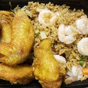 fried fish and rice in a black container