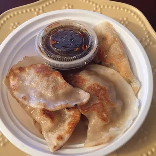 Pan fried dumplings. Tasty dipping sauce!