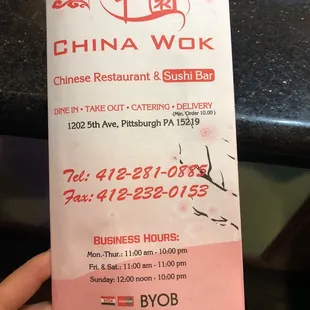 a hand holding a ticket for a restaurant