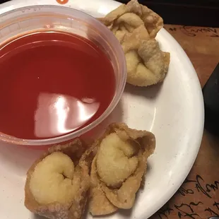 a plate of food with dipping sauce