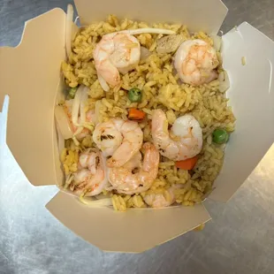 shrimp and rice in a paper container