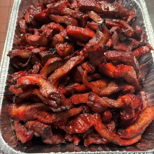 a tray of cooked bacon