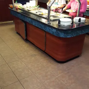 a buffet with people in the background