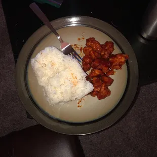 a plate of food with rice and meat