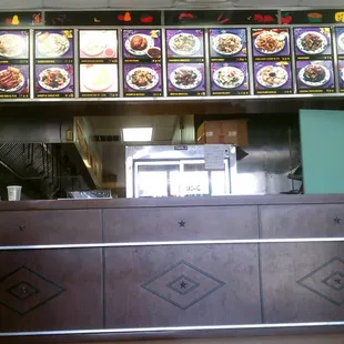 a restaurant counter with a lot of food on it