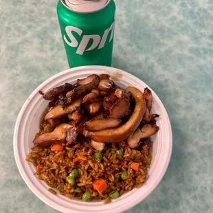 a can of soda and a plate of food