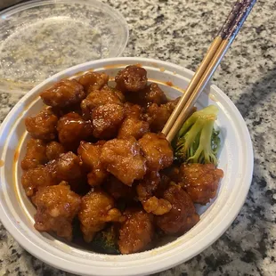 a bowl of food with chopsticks