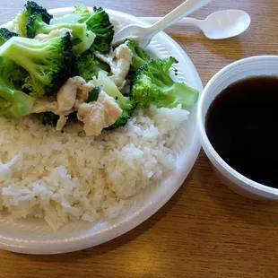 Steamed chicken with broccoli. Sauce on the side.