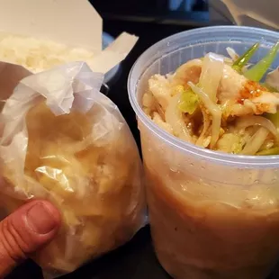 a person holding a container of food