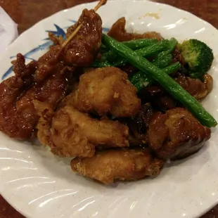 chicken, broccoli, and green beans on a white plate