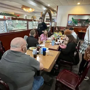a group of people eating at a restaurant