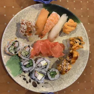 a plate of sushi and rolls