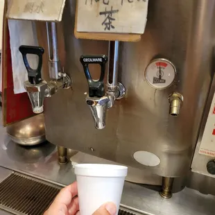 a person holding a cup of coffee