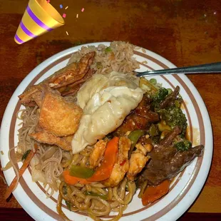 a plate of food with noodles and meat