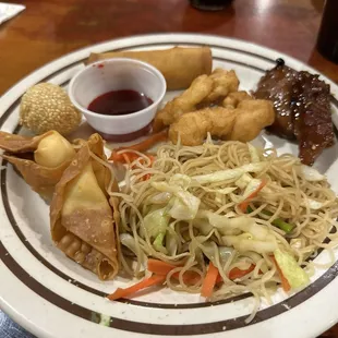 Crab Rangoon, rice boodles(pancit), sweet and sour chicken, sesame balls, and imperial chicken.