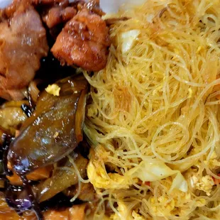 a plate of noodles, meat, and vegetables
