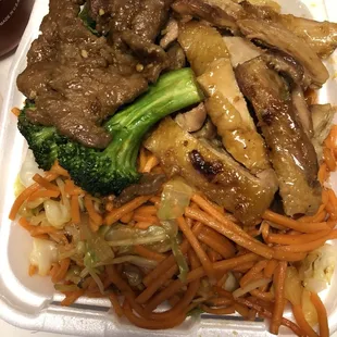 beef, broccoli, and carrots in a styrofoam container