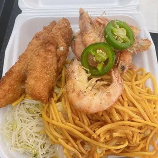 a takeout box with a meal of fried shrimp, noodles, and jalapeno peppers