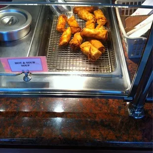 Hot rolls fresh off the egg roll making machine.