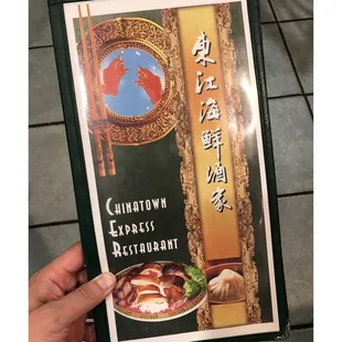 a hand holding a menu for a restaurant