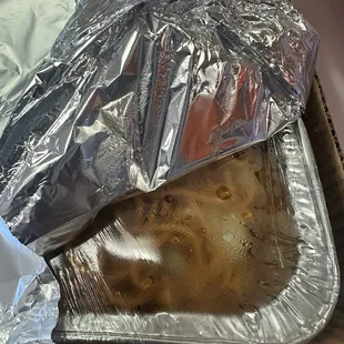 Half a tray of  orange and Teriyaki Chicken. Also a full tray of chowmein noodles.