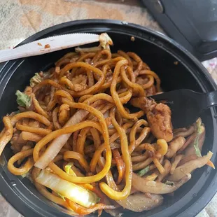 a plate of noodles and meat