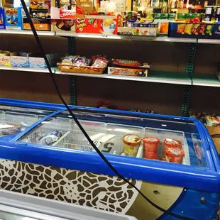 a blue and white ice cream freezer in a grocery store