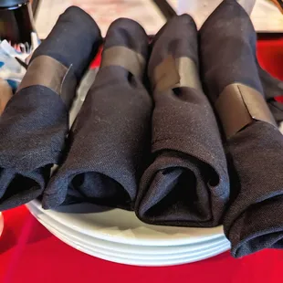 Napkins with utensils on small plates