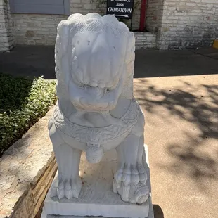 a stone statue of a dog