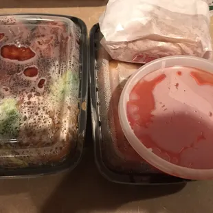 two trays of food and a container of ketchup