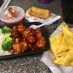 a tray of chicken, rice, and some vegetables