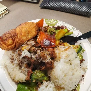 a plate of rice, meat and vegetables