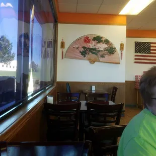 a woman sitting at a table looking out the window