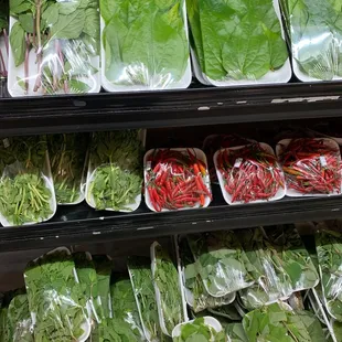 a variety of vegetables in plastic bags