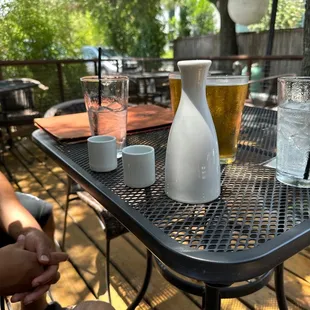 a person sitting at a table with drinks