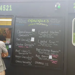 a man standing in front of a food truck